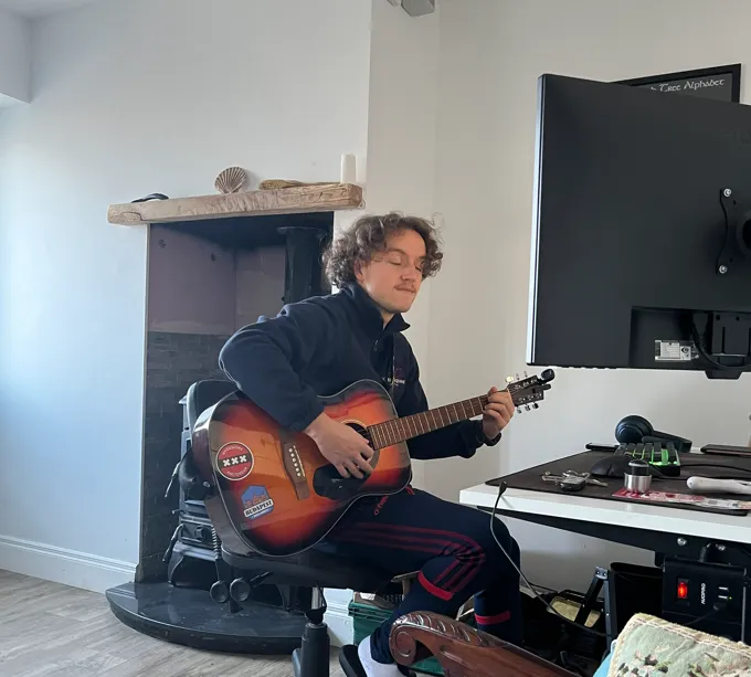 Cormac playing the guitar.